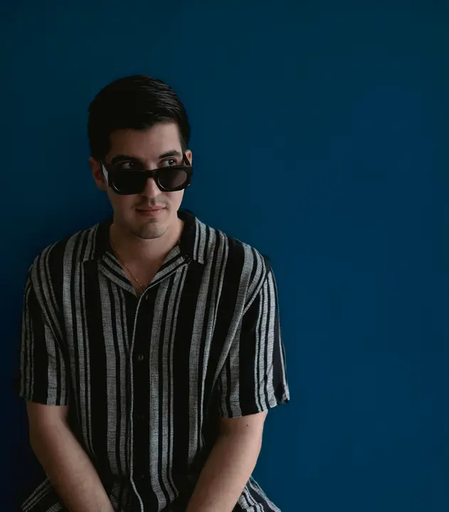 Press photo: Azul against a deep blue backdrop